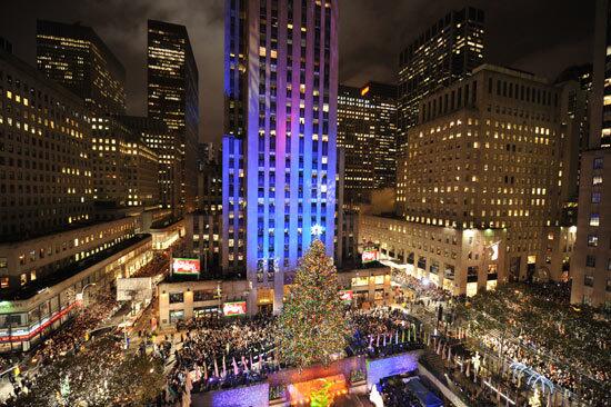 Crowds of spectators flock to Rockefeller Center to watch the annual tree lighting ceremony.