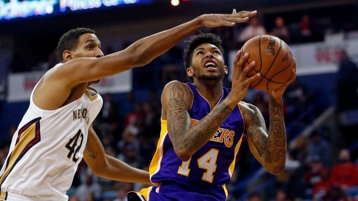 Lakers forward Brandon Ingram goes up for a shot against Pelicans center Alexis Ajinca during a game on Saturday.