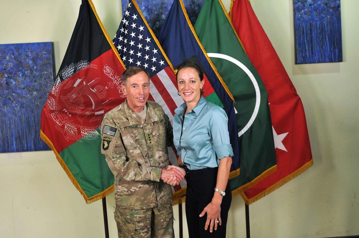 CIA Director Gen. Davis Petraeus shakes hands with biographer Paula Broadwell, co-author of "All In: The Education of General David Petraeus" on July 13, 2011. Petraeus resigned from his post on Nov. 9 citing an extra-marital affair with Broadwell.