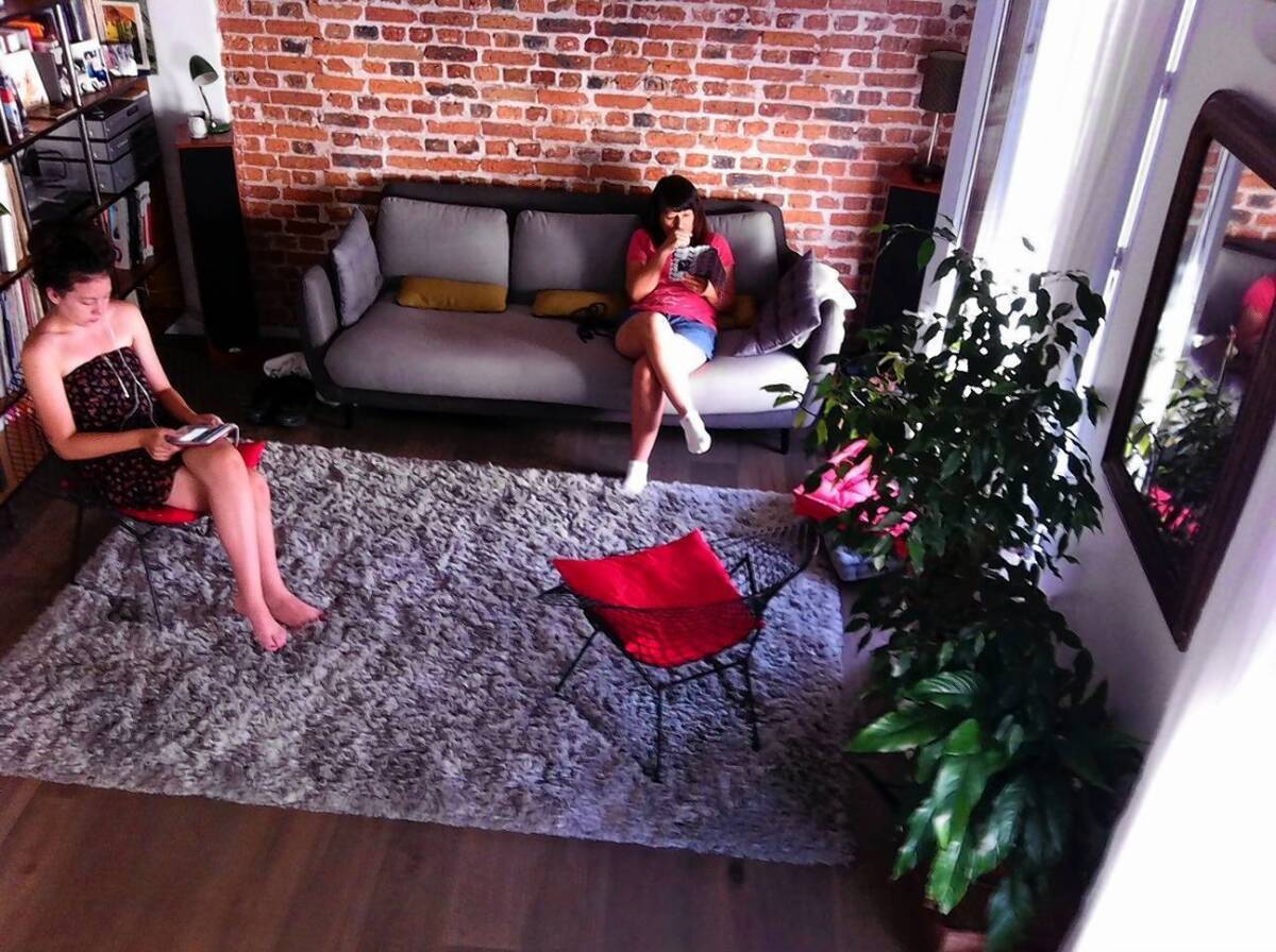 Hannah, left, and Nancy MacDonald relax in the home-swap apartment, an exchange that made a stay in Paris affordable.