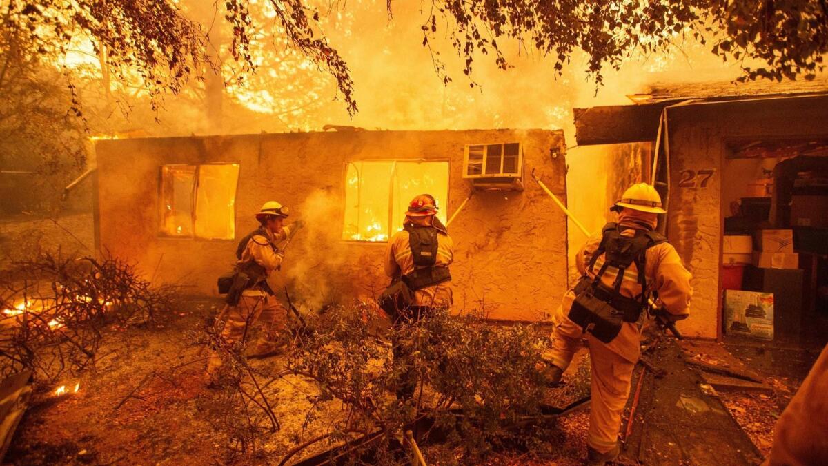 Firefighters had their work cut out for them in 2018, when wildland fires burned more acres in California than any other year in recorded state history. Above, crews battle the Camp fire in Paradise in November.