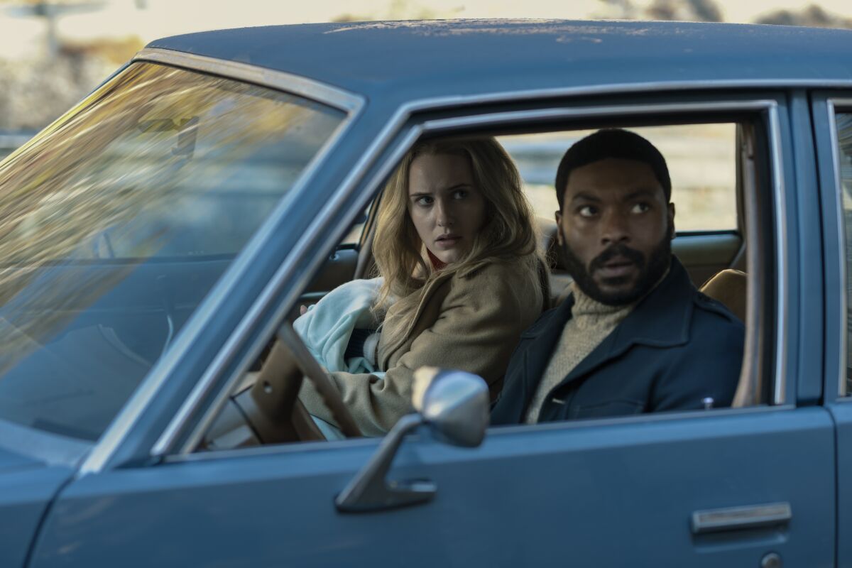 Rachel Brosnahan and Arinzé Kene sit in a car in "I'm Your Woman."