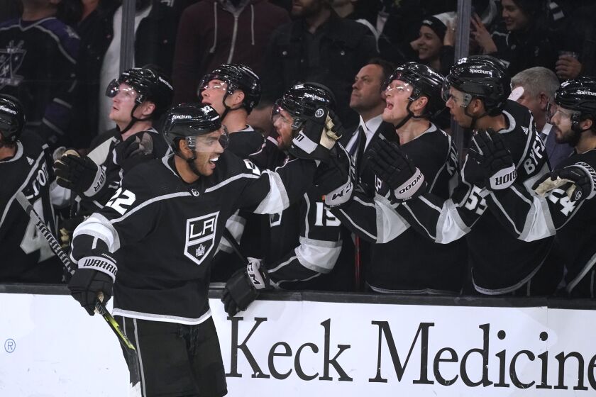 Los Angeles Kings center Andreas Athanasiou, left, is congratulated after scoring during the third period of the team's NHL hockey game against the Chicago Blackhawks on Thursday, April 21, 2022, in Los Angeles. (AP Photo/Marcio Jose Sanchez)