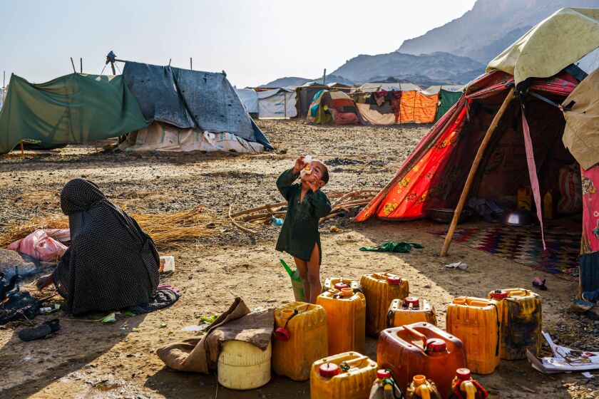 A young boy takes a drink at an IDP Camp in Panjwayi District, Afghanistan, Tuesday, May 4, 2021.