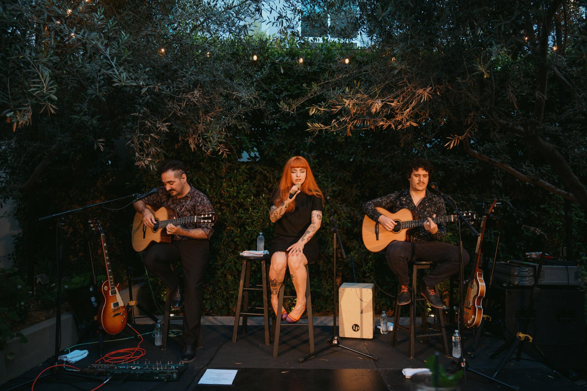 Mon Laferte, center, during a showcase in Los ?ngeles.