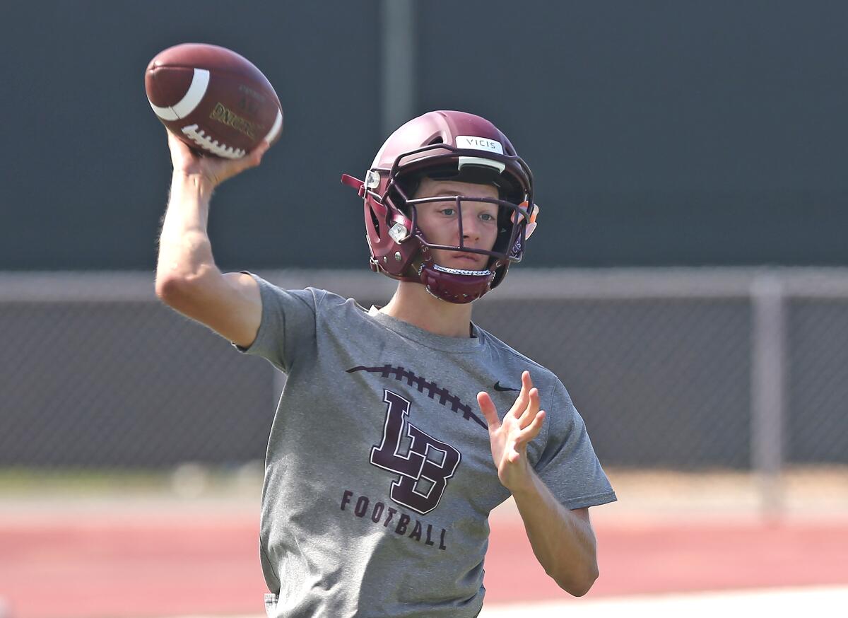 Andrew Johnson, the returning starting quarterback, makes a throw during practice at Laguna Beach on Aug. 2.