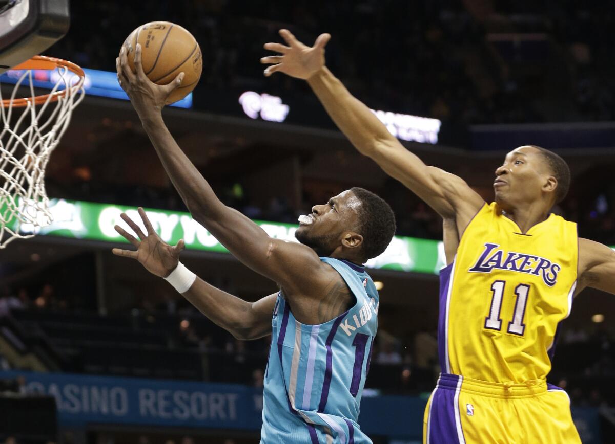 Hornets forward Michael Kidd-Gilchrist gets past Lakers forward Wesley Johnson for a layup in the first half Tuesday night in Charlotte, N.C.