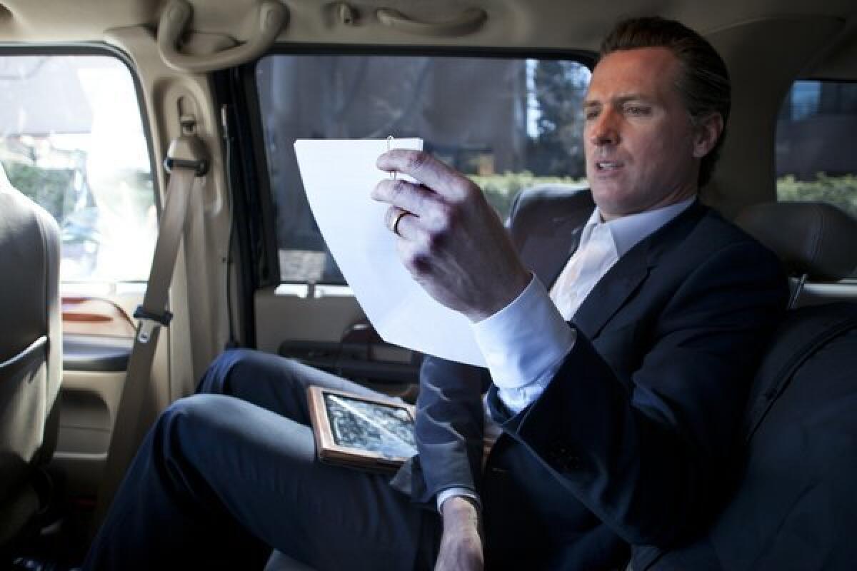 Lt. Gov. Gavin Newsom works in his California Highway Patrol-driven vehicle between speaking engagements in Silicon Valley in February.