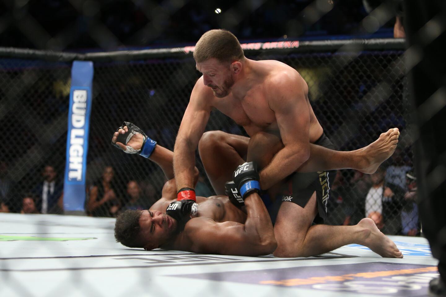 Stipe Miocic, top, punches Alistair Overeem on Sept. 10 at UFC 203 event in Cleveland.