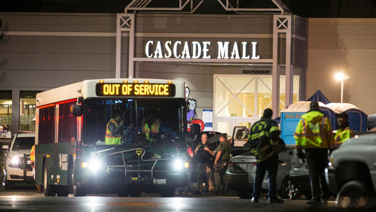Emergency personnel stand in front of an entrance to the Cascade Mall at the scene of a shooting in Burlington, Wash., on Sept. 23, 2016.