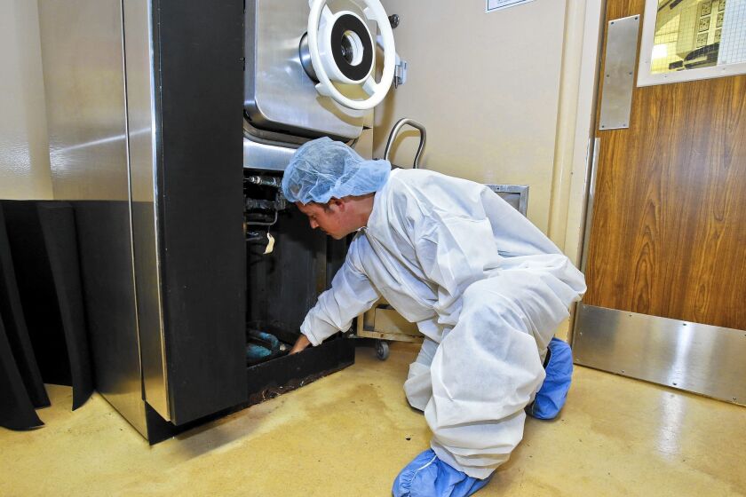 William Cordray of Water Saver Solutions in Long Beach points out how a device on a sterilizer at Tri-City Medical Center could end the need for a constant trickle.