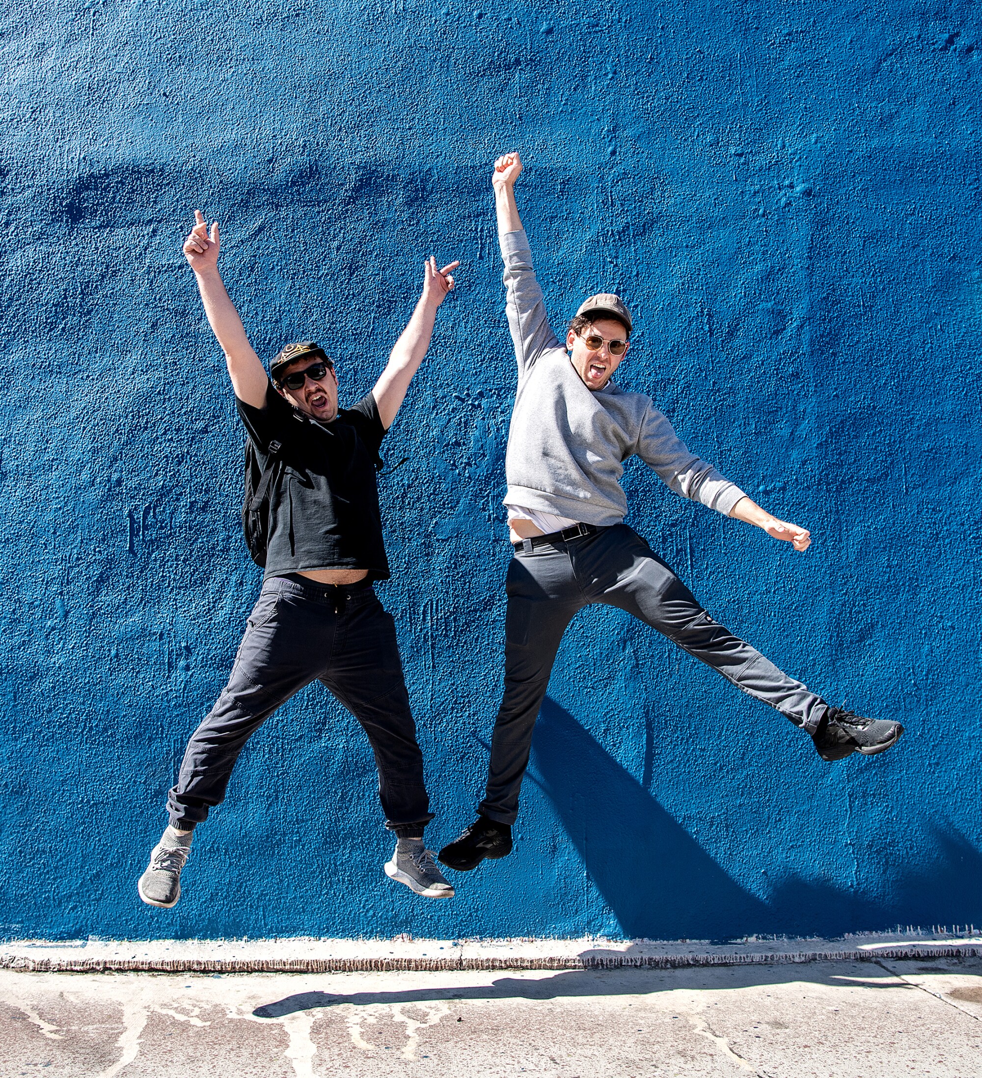Zachary Weathers and Brooke Palmieri jump up and pose on Sunset Boulevard.