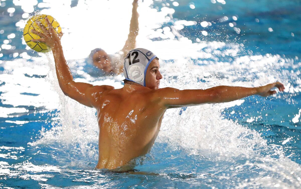 Corona del Mar's Charles Warmington takes a shot during the Battle of the Bay water polo match on Friday night.