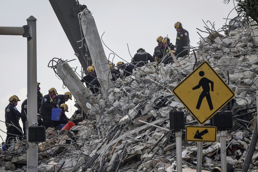 Search and rescue operations resumed as members of the Pennsylvania Search and Rescue team combed through the debris of the Champlain Tower South complex, Monday, July 5, 2021, in Surfside, Fla. (Carl Juste/Miami Herald via AP)
