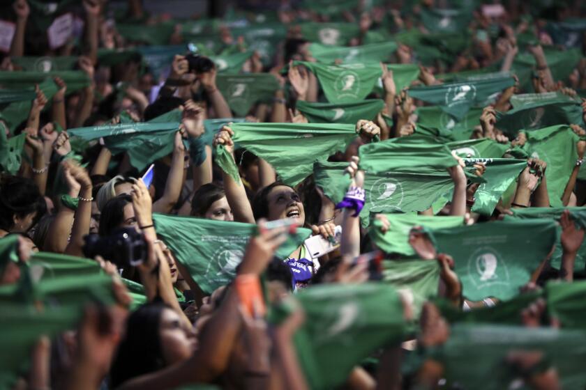 Thousands of pro-choice activists, including feminist groups from the U.S. and Chile, demonstrate in favor of decriminalizing abortion, outside Congress in Buenos Aires, Argentina, Wednesday, Feb. 19, 2020. Waving their iconic green handkerchiefs, the demonstrators are demanding the issue be included in this year's parliamentary agenda. (AP Photo/Natacha Pisarenko)