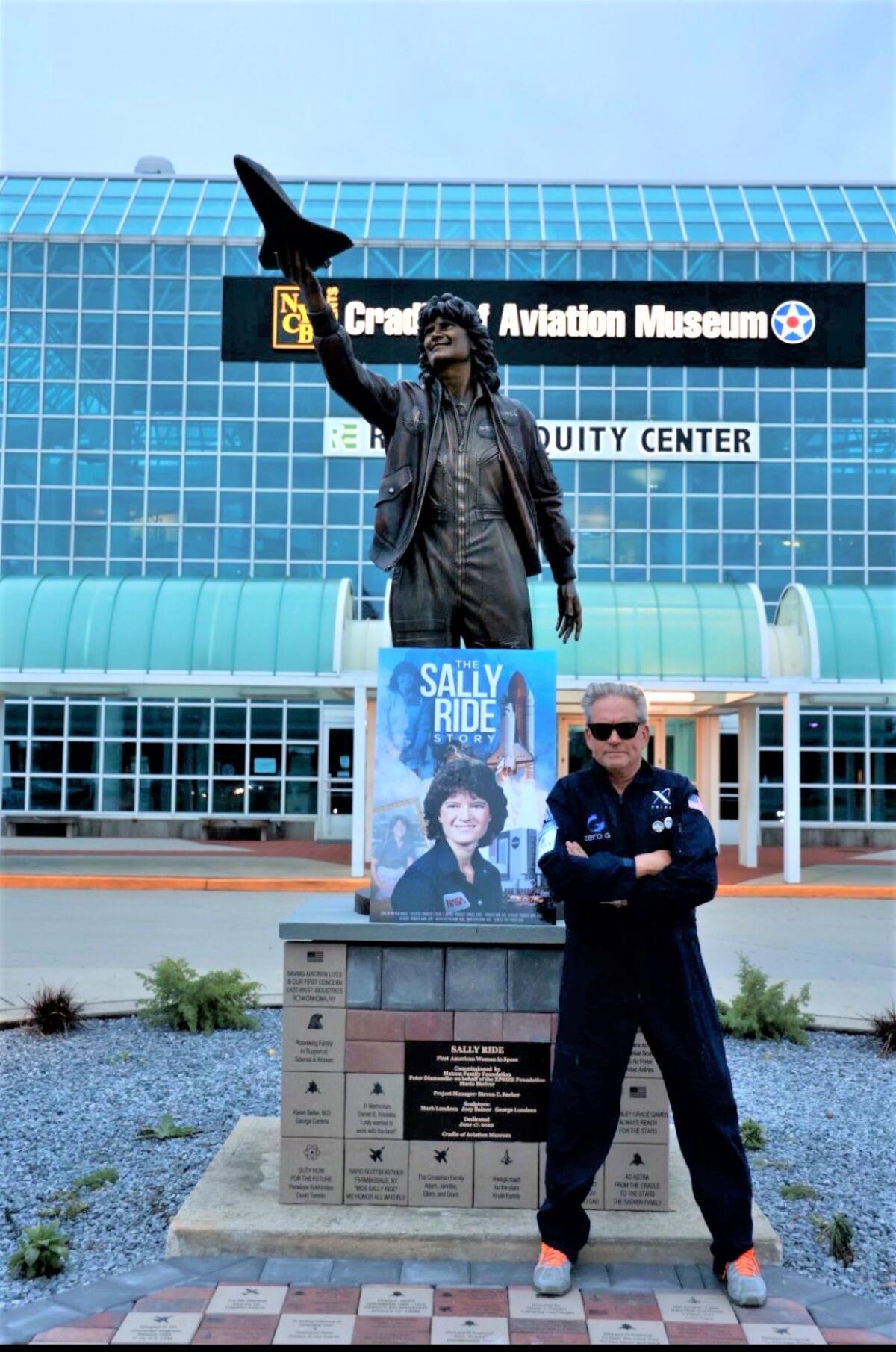 Steven Barber stands with the Sally Ride monument he established in June at the Cradle of Aviation Museum in New York. 