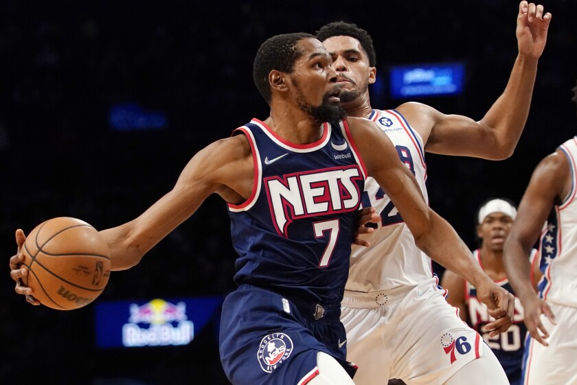 Brooklyn Nets forward Kevin Durant (7) drives to the basket against Philadelphia 76ers forward Tobias Harris (12) during the second half of an NBA basketball game, Thursday, Dec. 16, 2021, in New York. The Nets won 114-105. (AP Photo/Mary Altaffer)