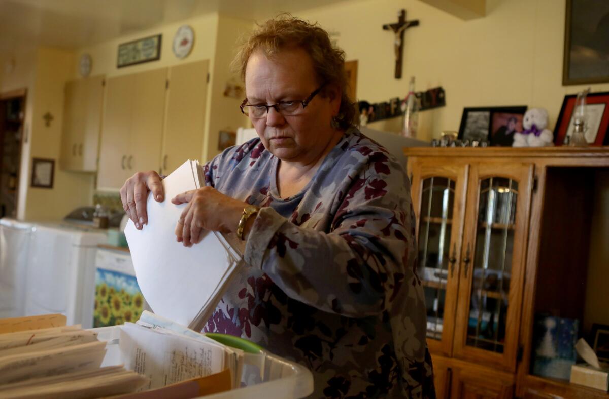 Chole Butler goes through the "cancer box" with her husband at their home in Sidney, Mont.