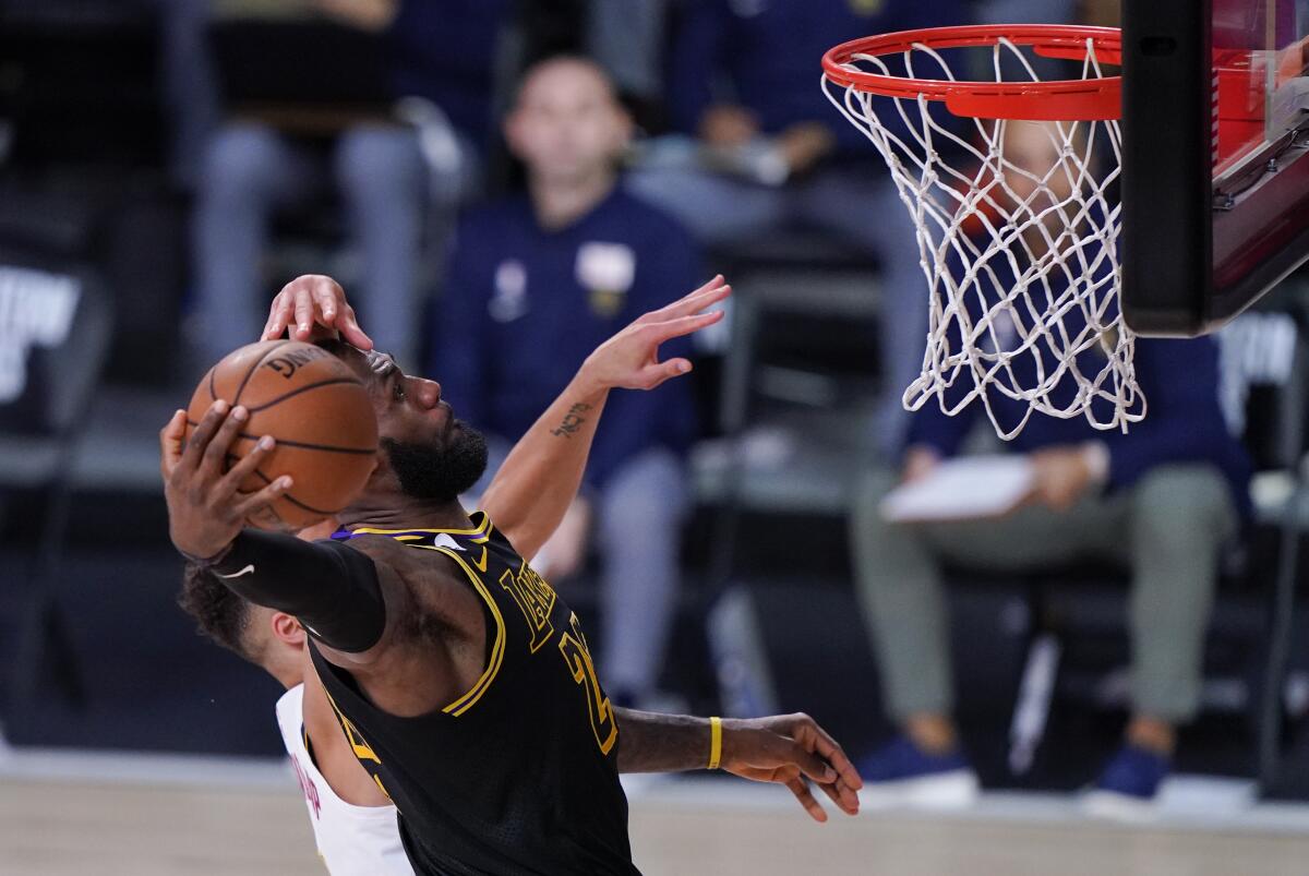 Lakers forward LeBron James is fouled by Nuggets forward Michael Porter Jr. during Game 2.