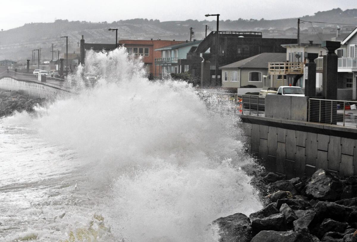 Waves pound a sea wall in Pacifica, Calif., in 2010. Sea levels off the West Coast have been depressed in recent years because of a weather pattern that has lowered ocean temperatures, scientists say. But that is due to reverse.