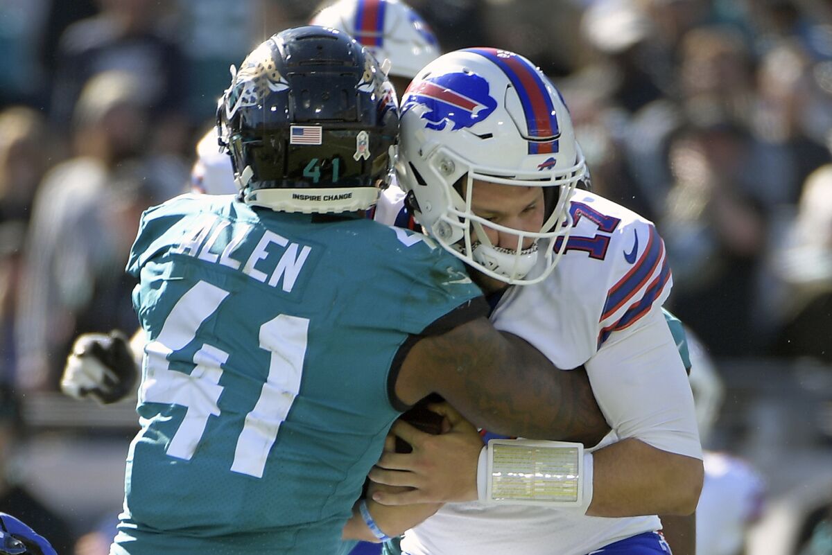 Jacksonville Jaguars linebacker Josh Allen (41) sacks Buffalo Bills quarterback Josh Allen (17) during the first half of an NFL football game, Sunday, Nov. 7, 2021, in Jacksonville, Fla. (AP Photo/Phelan M. Ebenhack)