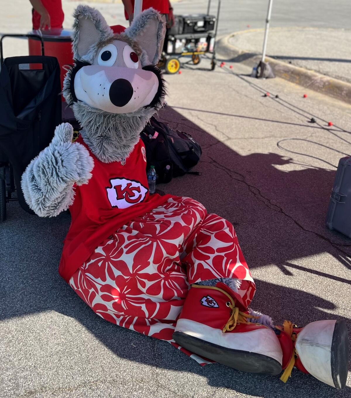 Kansas City Chiefs mascot KC Wolf lounges in a parking lot.