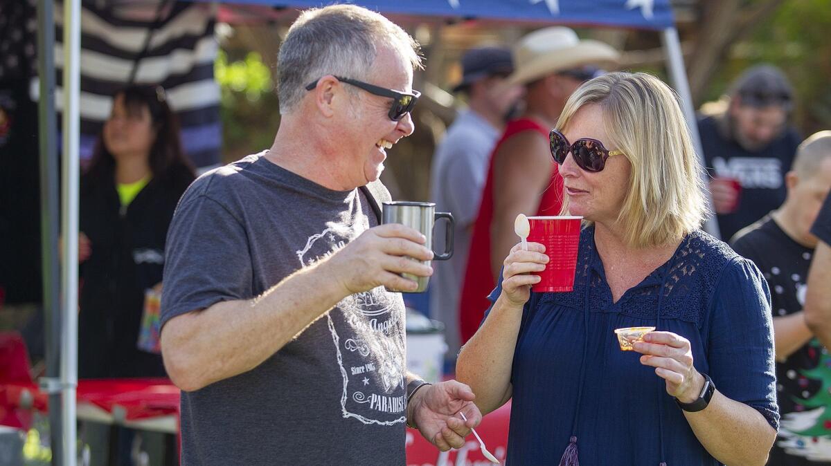 Gary Smart, left, and Jacquie Blair share a laugh during the annual Halecrest Park Chili Cook Off on Saturday.