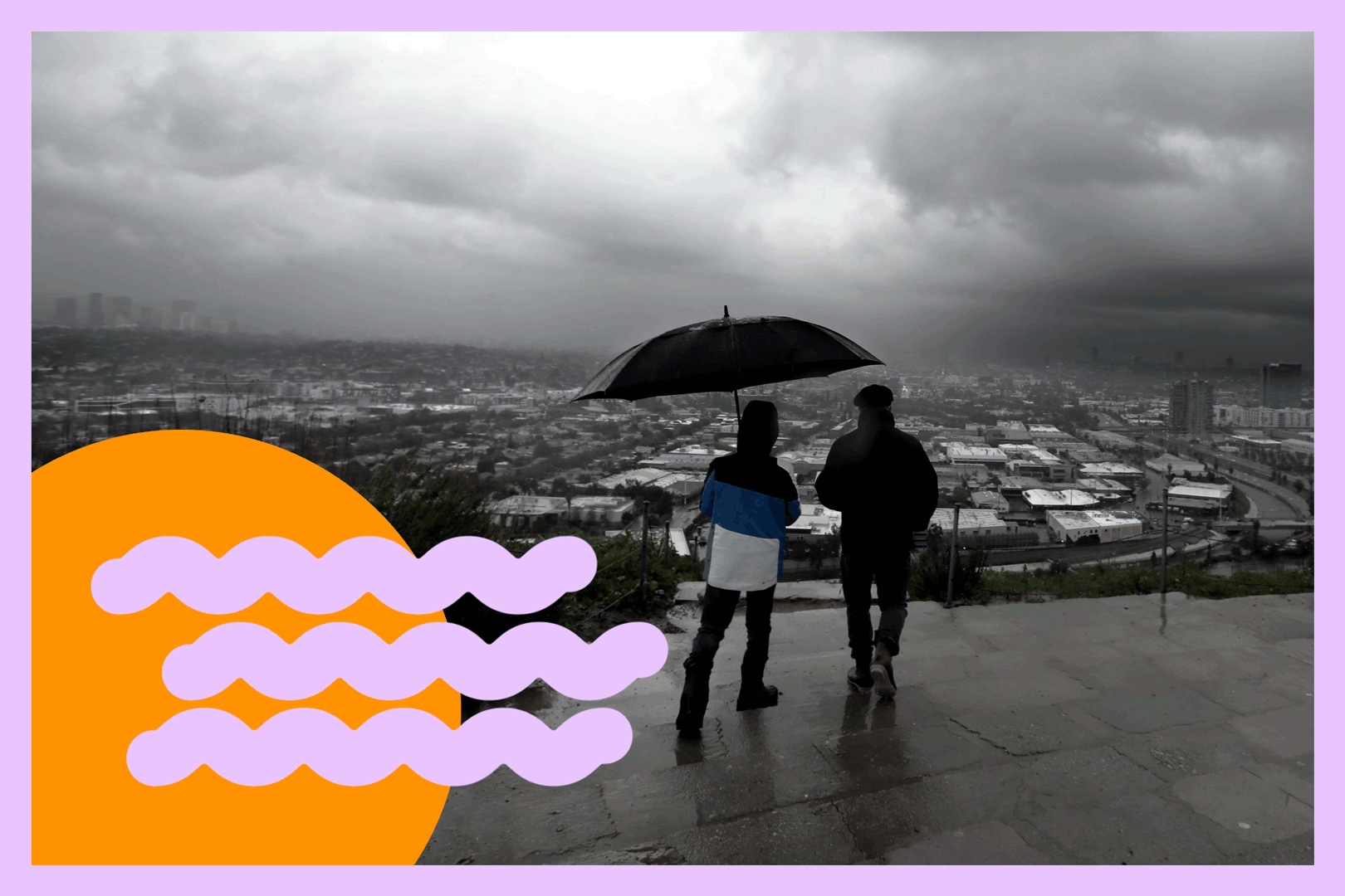Warren and his son Johnny take in the view of a passing storm from the Baldwin Hills Scenic Overlook in Culver City