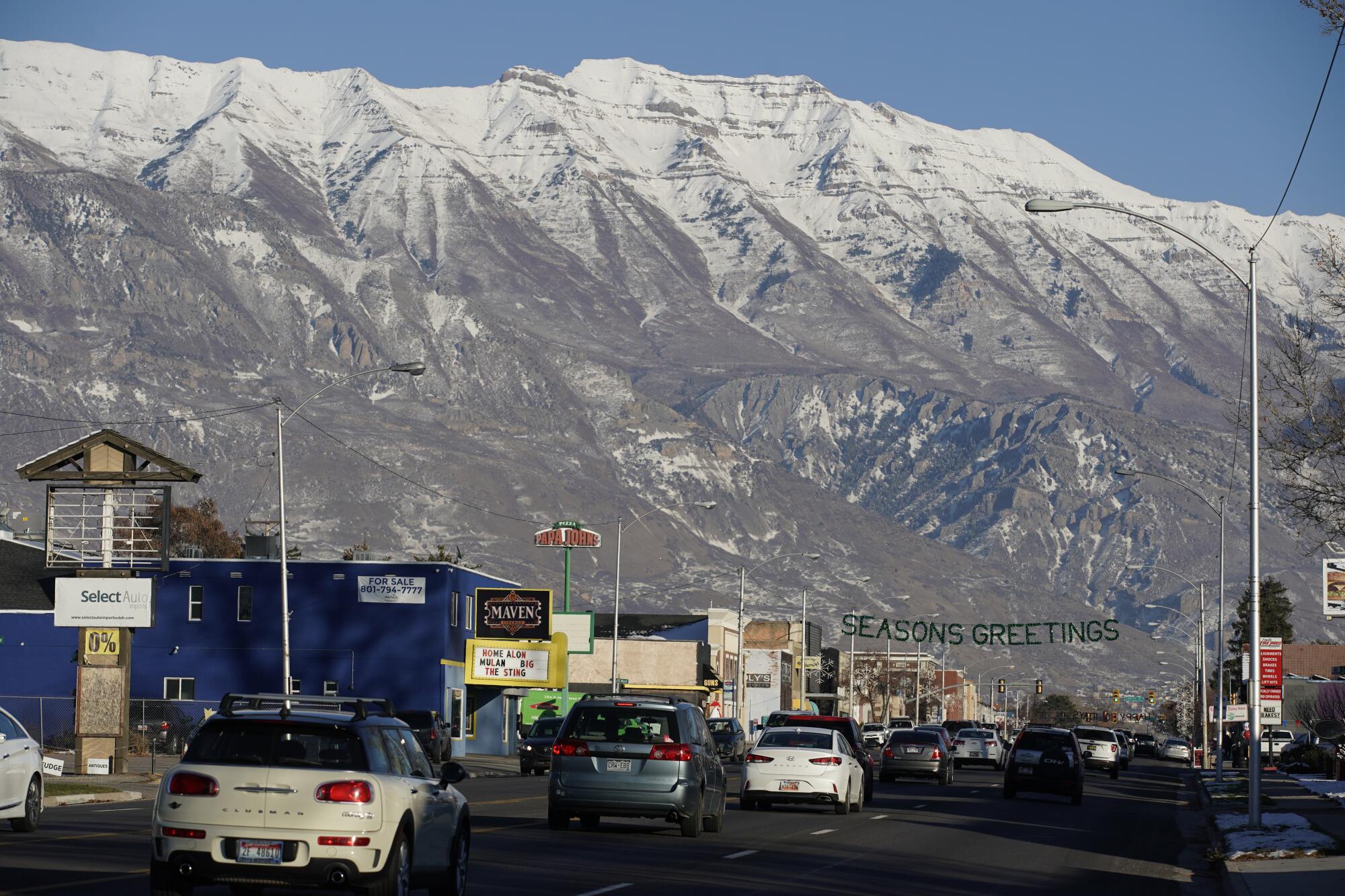 Snow-capped mountains rise over downtown American Fork, Utah.