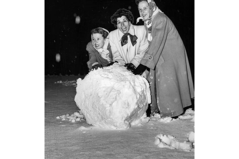 Jan. 11, 1949: Jean Rogers, Mrs. Ted Fio Rito and Mrs. Harvey Holp roll a big snowball in a front yard in Bel Air. This photo was published in the Jan. 12, 1949 Los Angeles Times.