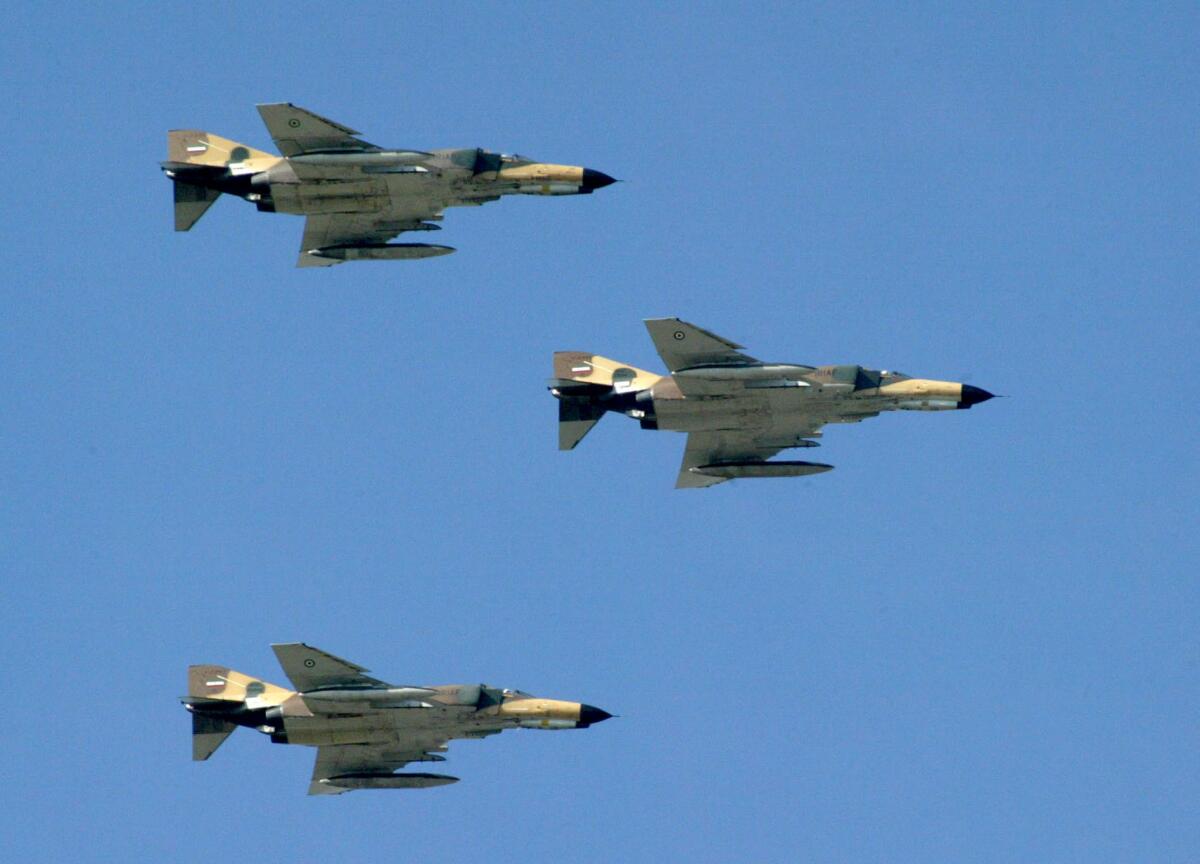 Iranian air force fighter jets fly over Tehran.