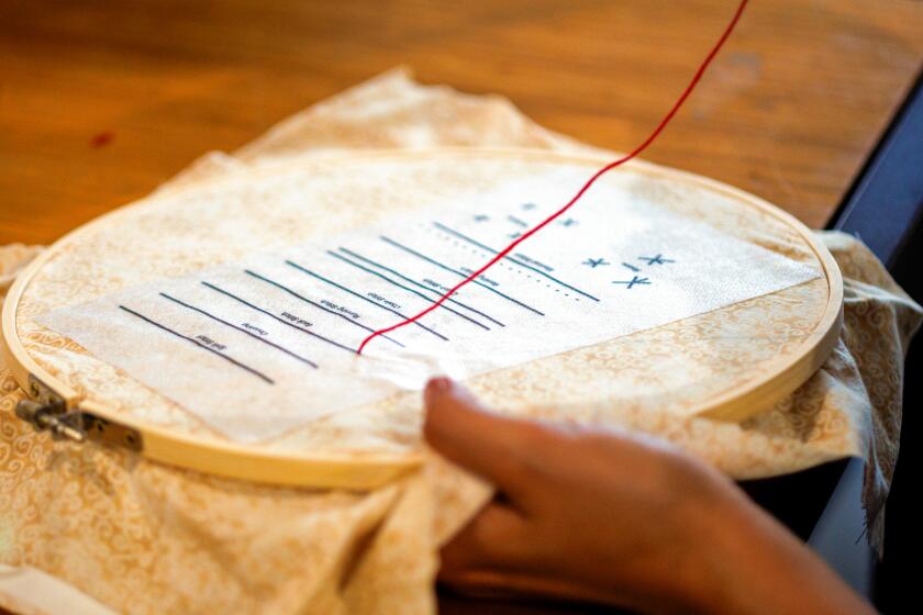 A close up of someone using an embroidery circle.