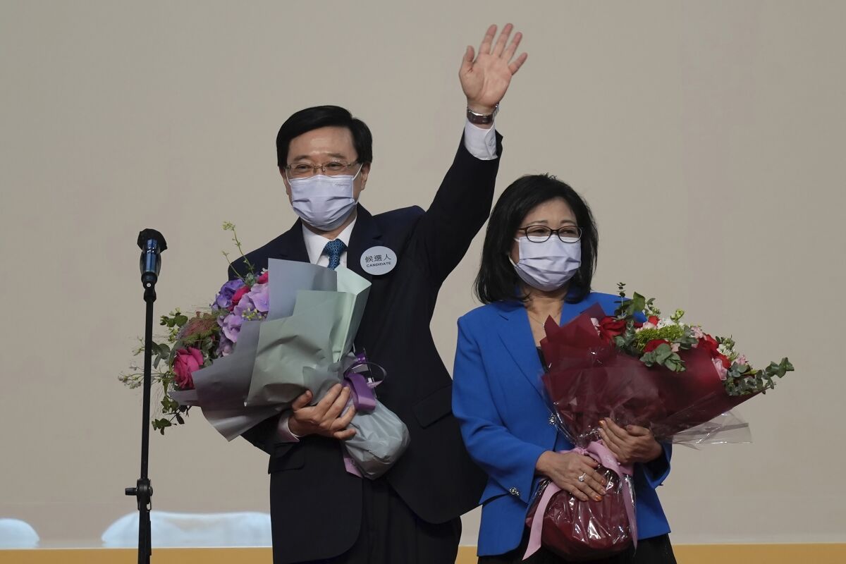 John Lee, Hong Kong's newly elected leader, celebrates his victory with his wife on Sunday.
