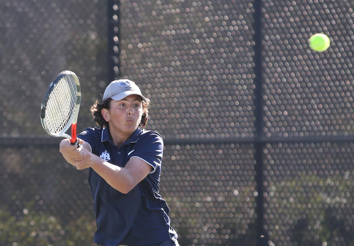 Newport Harbor doubles player Ben Chlarson hits a winning volley in a season opener against Newport Harbor on Tuesday in Newport Beach.