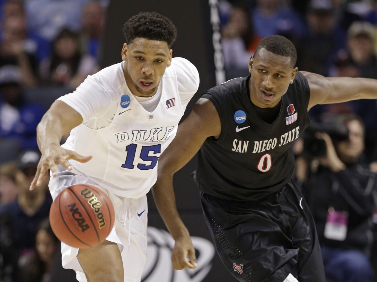 Duke's Jahlil Okafor (15) and San Diego State's Skylar Spencer (0) chase a loose ball during the second half of an NCAA tournament game on March 22.
