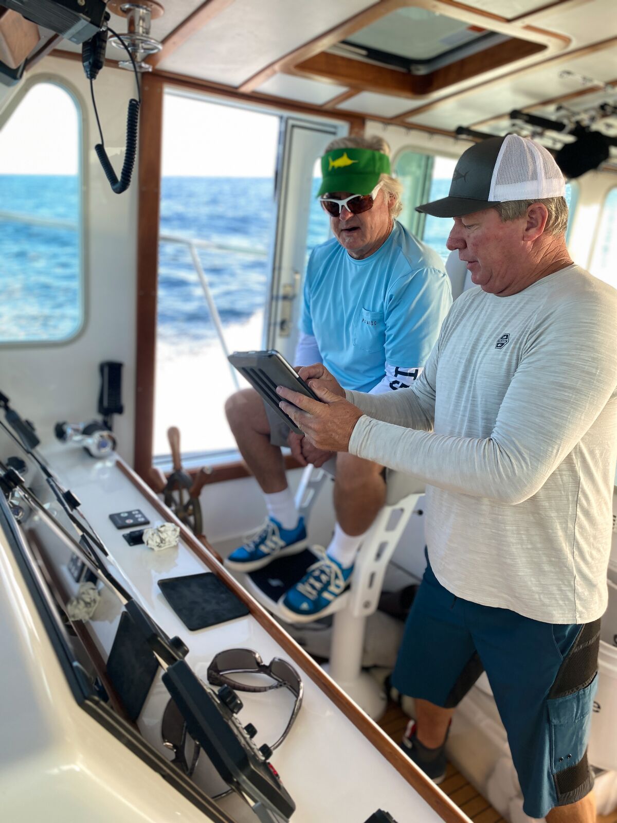 RV Pilar captain Jake Russell (left) and second captain Bob Woodard work to remove plastics from local waters.
