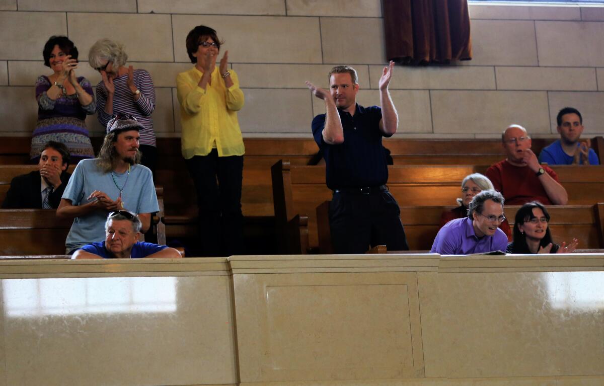 Spectators applaud the Nebraska Legislature's override of Gov. Pete Ricketts' veto of a death-penalty repeal bill. The vote makes Nebraska the first traditionally conservative state to ban capital punishment since North Dakota in 1973.