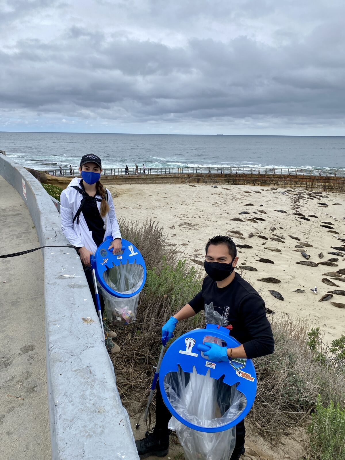 Marie Butler and J.P. Rosal aided the Seal Society's Earth Day efforts to rid the Children's Pool beach of litter.