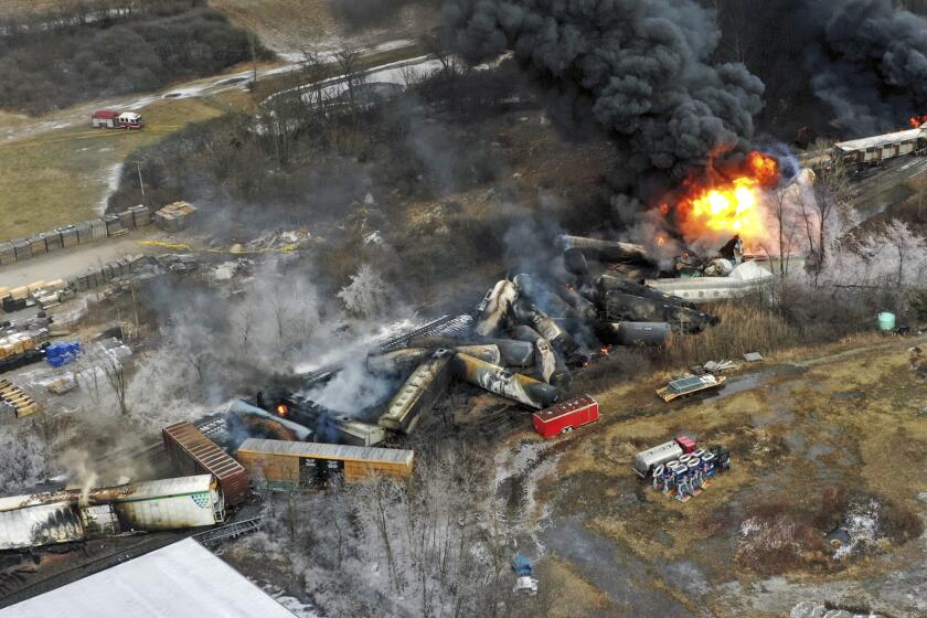 FILE - In this photo taken with a drone, portions of a Norfolk Southern freight train that derailed the previous night in East Palestine, Ohio, remain on fire at mid-day on Feb. 4, 2023. Transportation Secretary Pete Buttigieg announced a package of reforms to improve safety Tuesday, Feb. 21 — two days after he warned the railroad responsible for the derailment, Norfolk Southern, to fulfill its promises to clean up the mess just outside East Palestine, and help the town recover. (AP Photo/Gene J. Puskar, File)