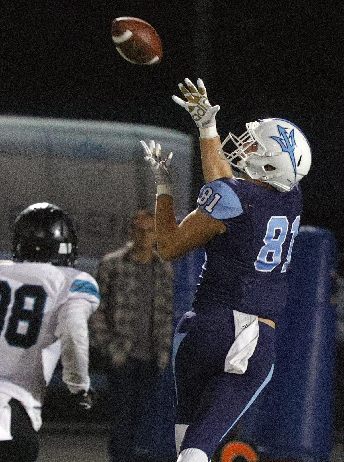 Corona del Mar's Mark Redman gets under a long pass against Santiago that leads to a touchdown in the first round of the CIF Southern Section Division 3 playoffs on Friday at Newport Harbor High.