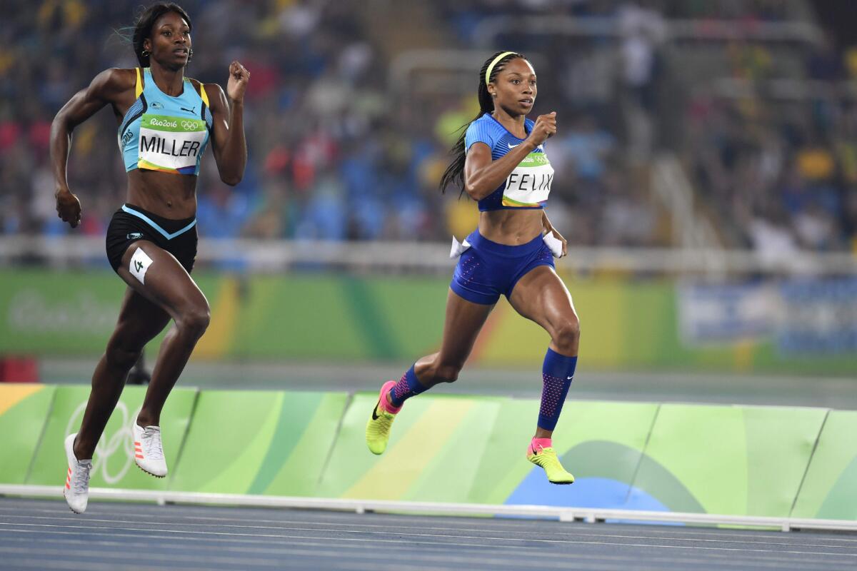 U.S. sprinter Allyson Felix, right, finishes ahead of Bahamas's Shaunae Miller in the women's 400-meter semifinal at the Rio Olympics on Aug. 14.