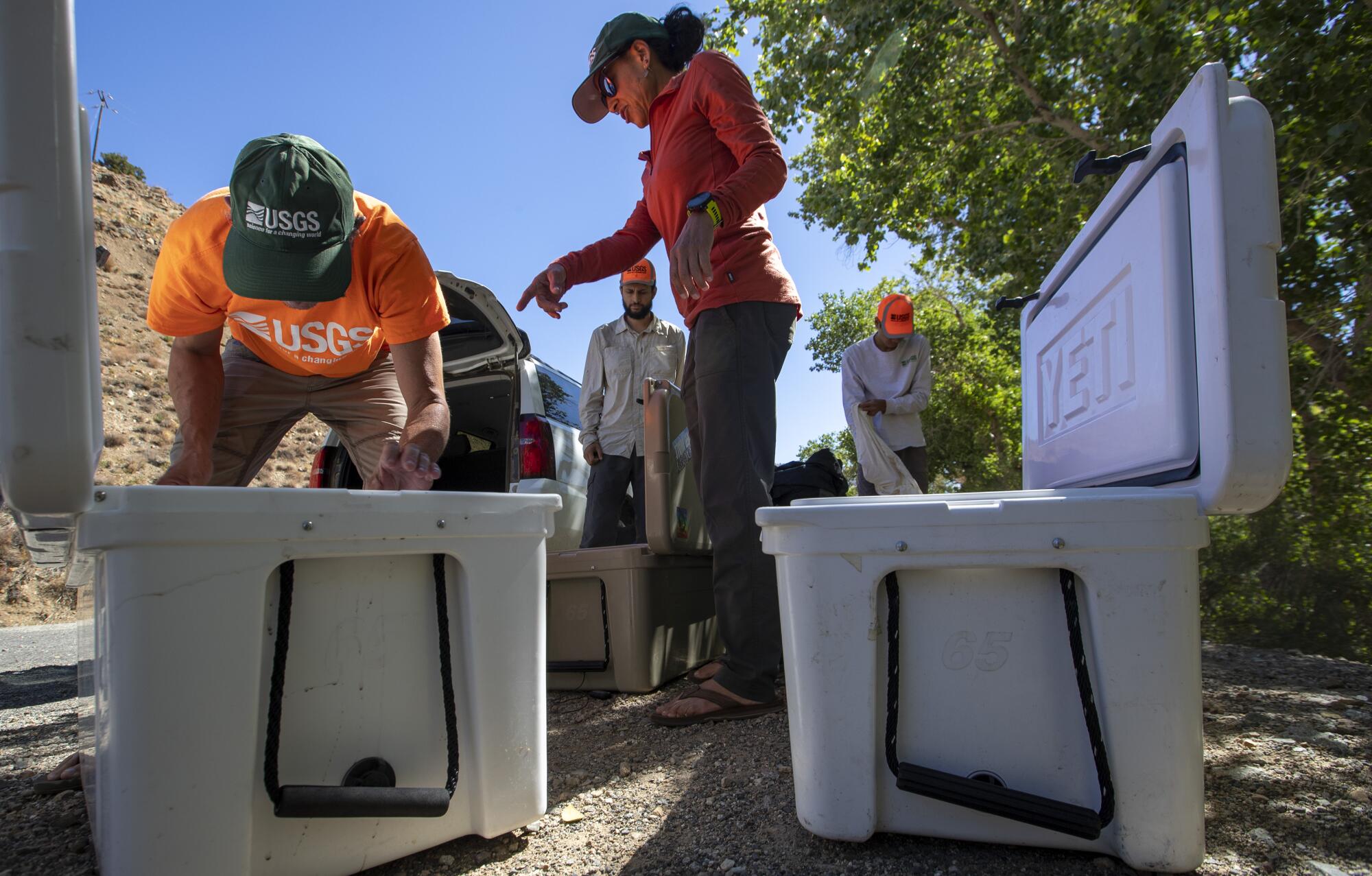 U.S. Geological Survey biologist Liz Gallegos, center, directs teammates in Angeles National Forest