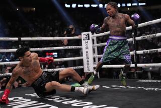 Gervonta Davis knocks down Ryan Garcia during a lightweight boxing bout Saturday.