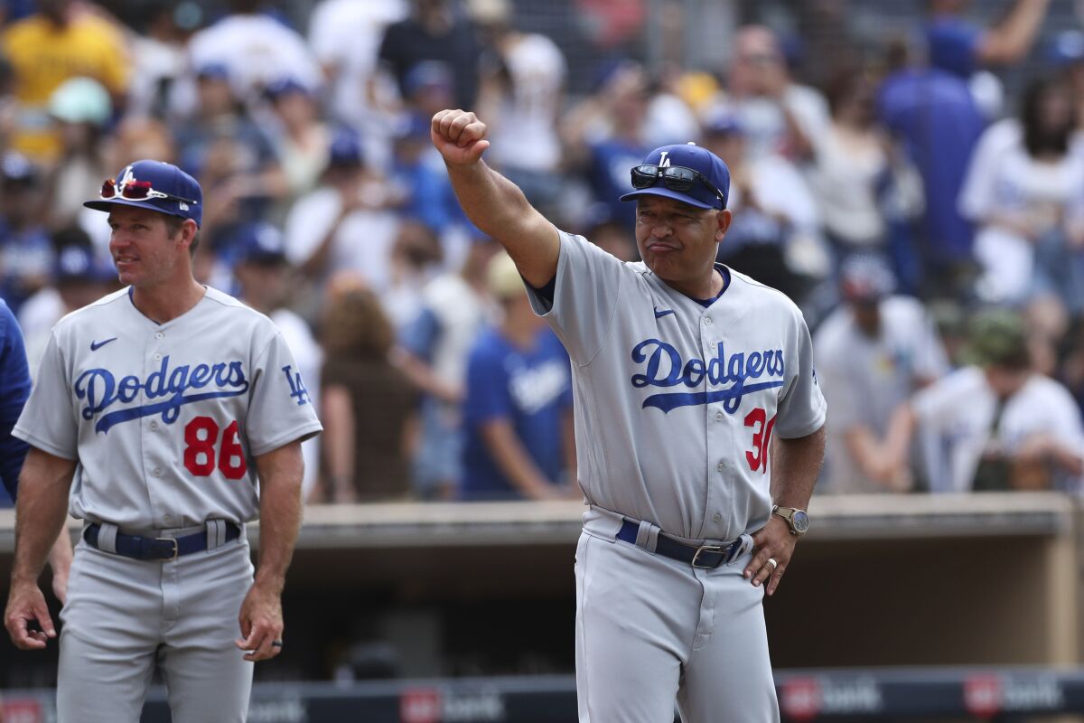 Dodgers manager Dave Roberts gestures to the crowd after an 11-2 victory over the San Diego Padres.