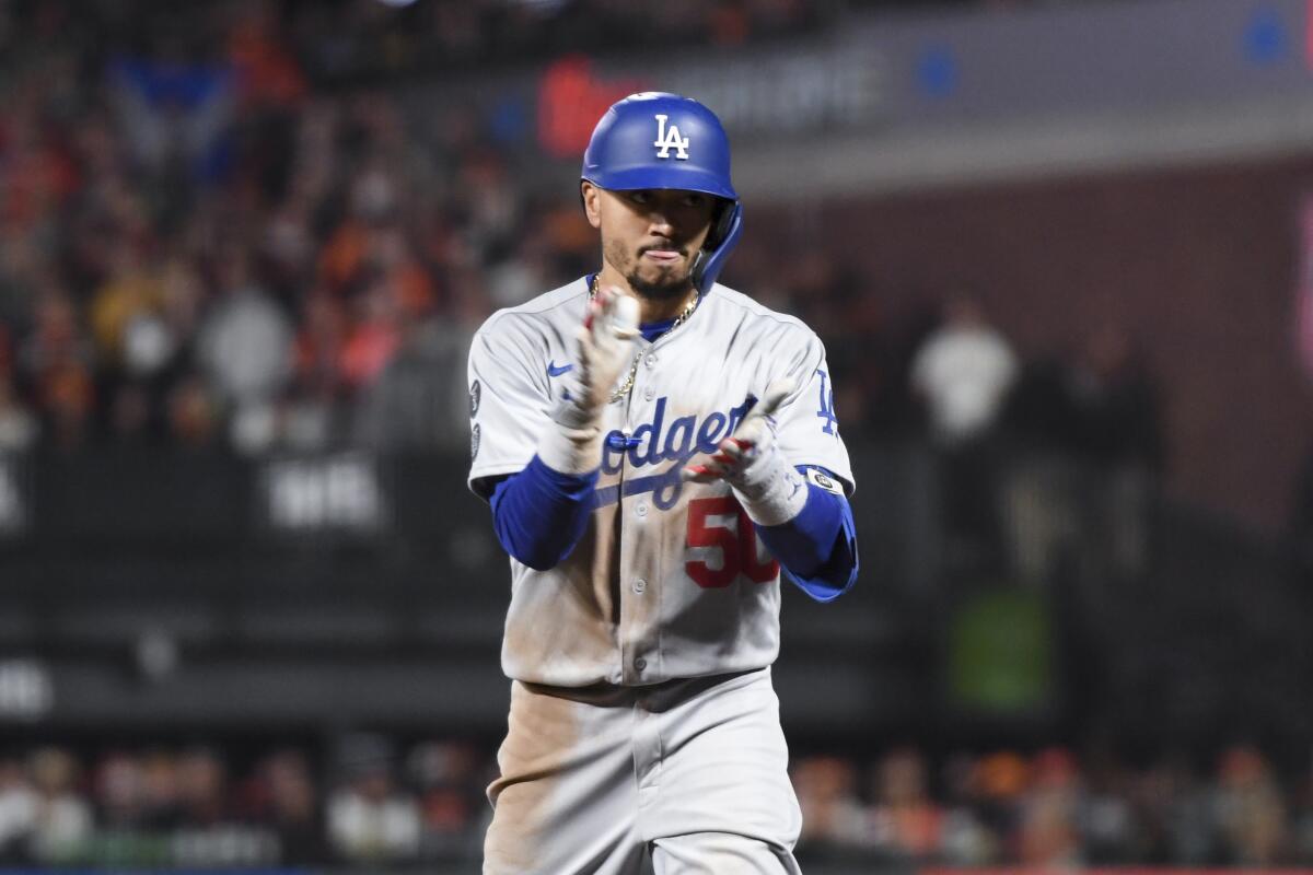 Mookie Betts celebrates after hitting a single during the eighth inning in the Dodgers' 2-1 win.