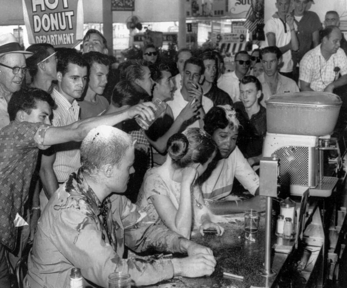 A May 28, 1963, sit-in demonstration at a Woolworth's lunch counter in Jackson, Miss., turned violent when whites poured sugar, ketchup and mustard over the heads of demonstrators, from left, John Salter, Joan Trumpauer and Anne Moody.