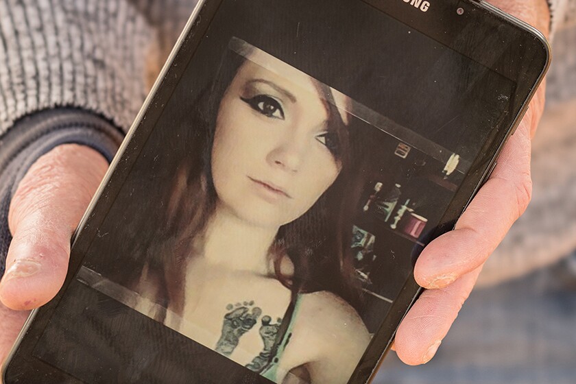 An image of Chelsea Becker is shown on a phone.