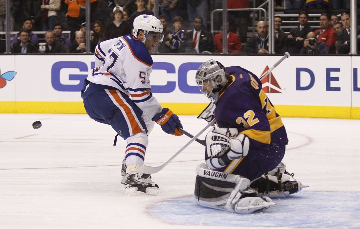 Kings goalie Jonathan Quick, right, makes a shootout save on Edmonton Oilers forward David Perron during the Kings' win Sunday.