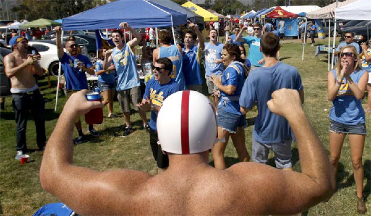 UCLA Bruins fans show their spirit as they confront Nebraska Cornhuskers fan Sean Quinn, of Valencia, and a large group of Husker fans before the Bruins' home opener at the Rose Bowl on Sept. 8, 2012.