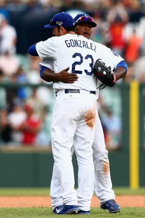 Adrian Gonzalez and Juan Uribe celebrate the Dodgers' 7-5 victory over Arizona on Sunday, completing a two-game, season-opening sweep of the Diamondbacks in Sydney, Australia.